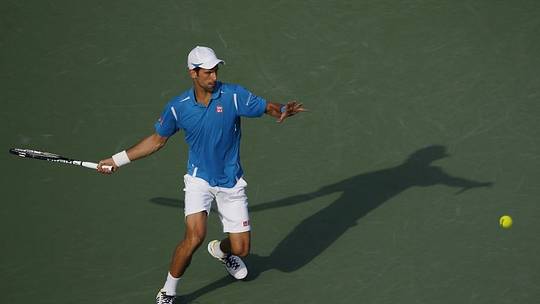 Mar 27, 2016; Key Biscayne, FL, USA; Novak Djokovic hits a forehand against Joao Sousa (not pictured) during day six of the Miami Open at Crandon Park Tennis Center. Djokovic won 6-4, 6-1. Mandatory Credit: Geoff Burke-USA TODAY Sports